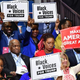 Herman Cain (C,L) and supporters of US President Donald Trump “Black Voices” listen to him speak during a campaign rally at the BOK Center on June 20, 2020 in Tulsa, Oklahoma.